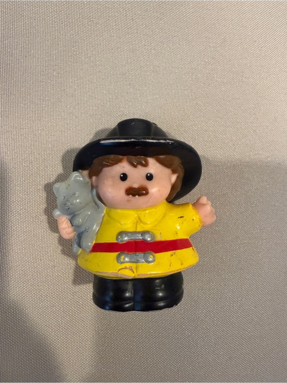 Fisher-Price Yellow Firefighter Toy with Black Hat and Gray Cat